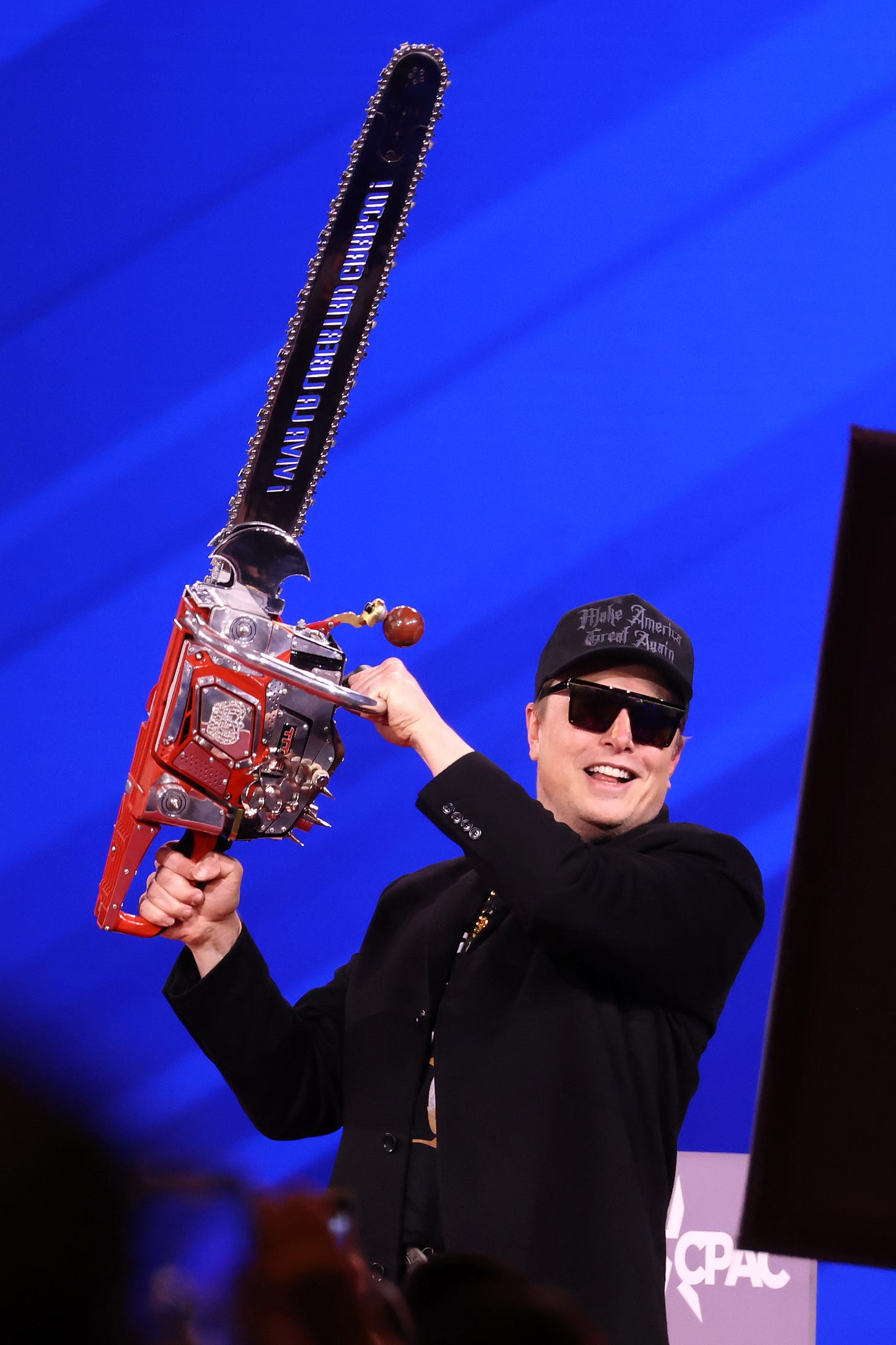 Elon Musk hoists a chainsaw on stage at CPAC 2025 Elon Musk hoists a chainsaw on stage at CPAC 2025