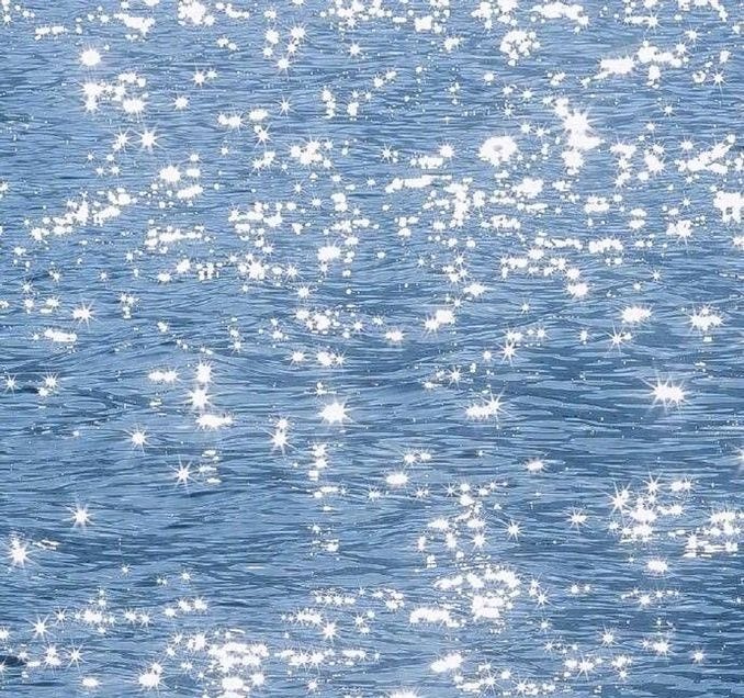 This may contain: a man riding a surfboard on top of a body of water with stars all over it This may contain: a man riding a surfboard on top of a body of water with stars all over it