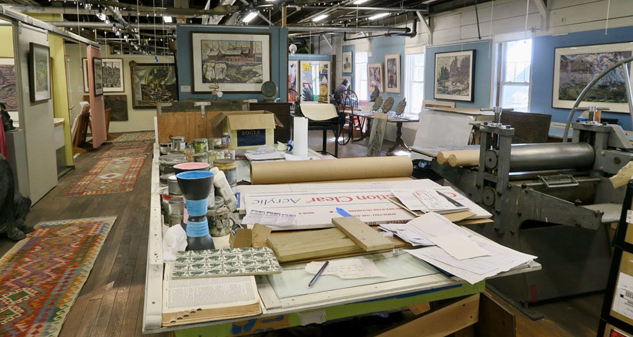A picture containing text, indoor, cluttered, worktable

Description automatically generated
