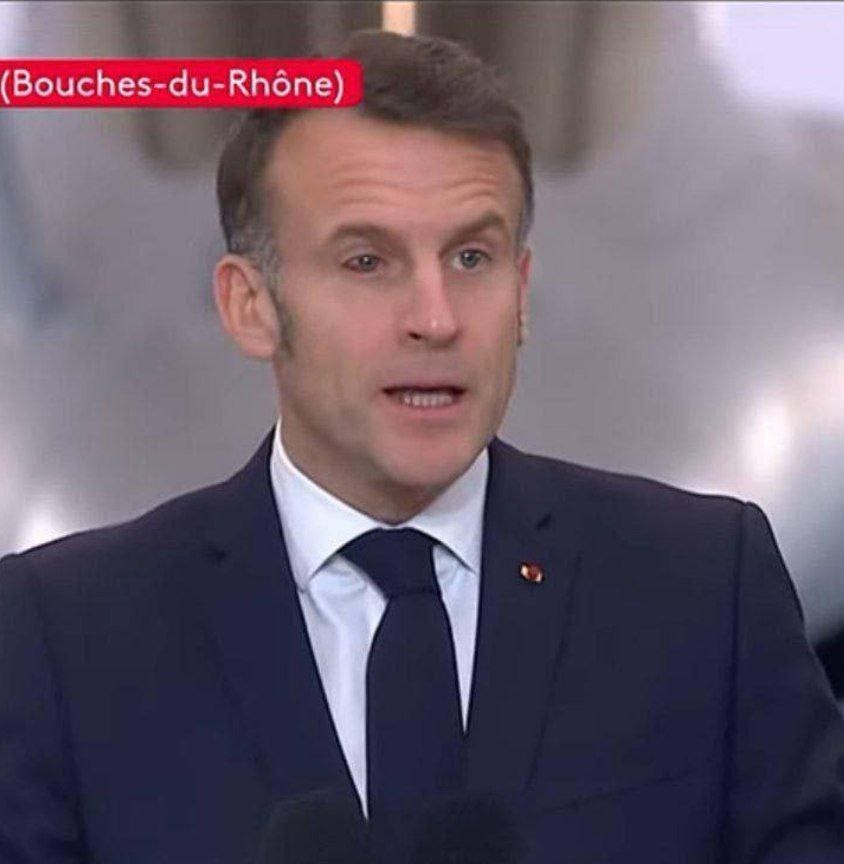 A dark-haired man in a suit is speaking into a microphone; the words "Bouches-du-Rhône" can be seen in the picture.