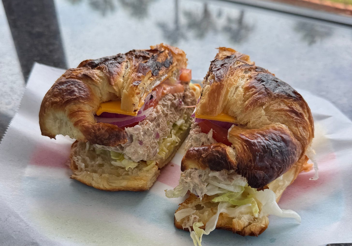 A sandwich cut in half on a plate

Description automatically generated