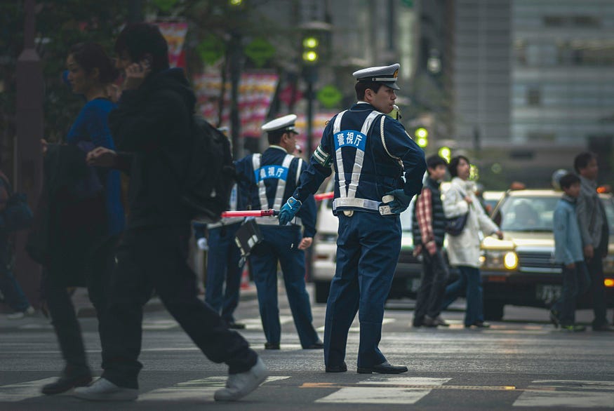 Japanese police directing traffic. Japanese police directing traffic.