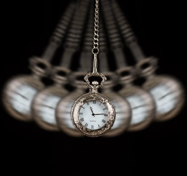 This may contain: an antique pocket watch hanging from a chain