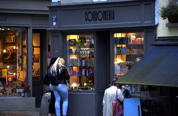 A group of people standing outside a store

AI-generated content may be incorrect.