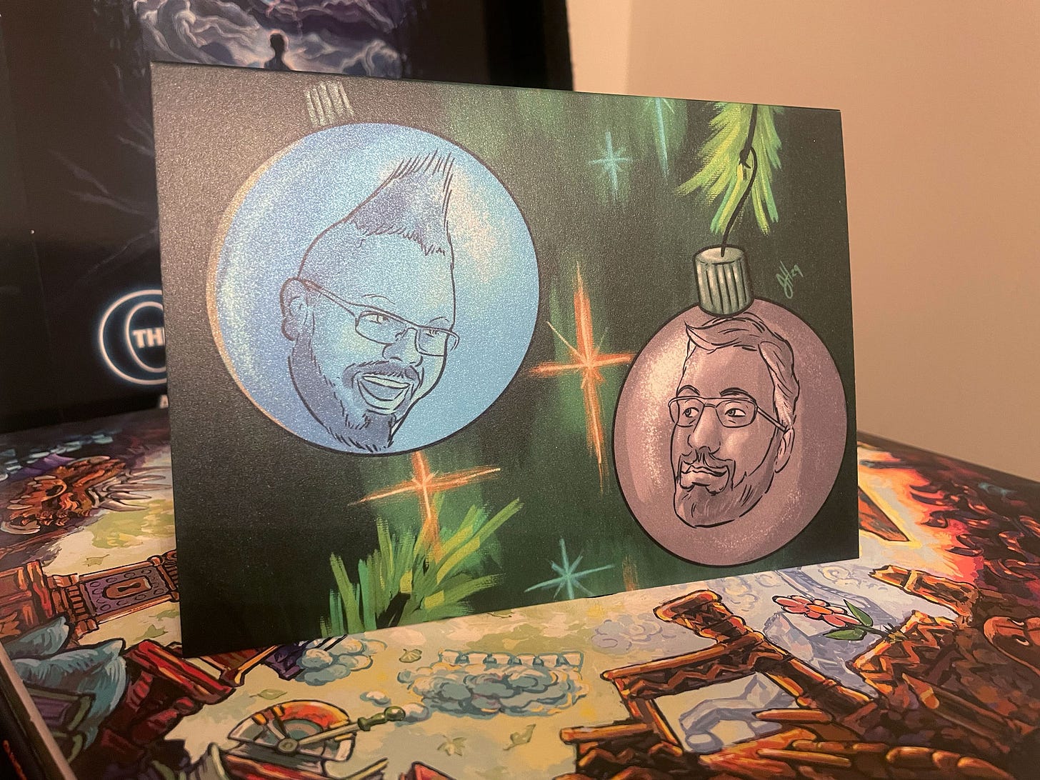 This year's holiday card features my partner, Paul and I, with our heads floating in ornaments with a vintage style background of stylized tree branches and lights