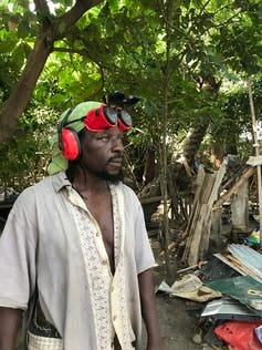 Man standing with goggles on his head and a shirt Man standing with goggles on his head and a shirt