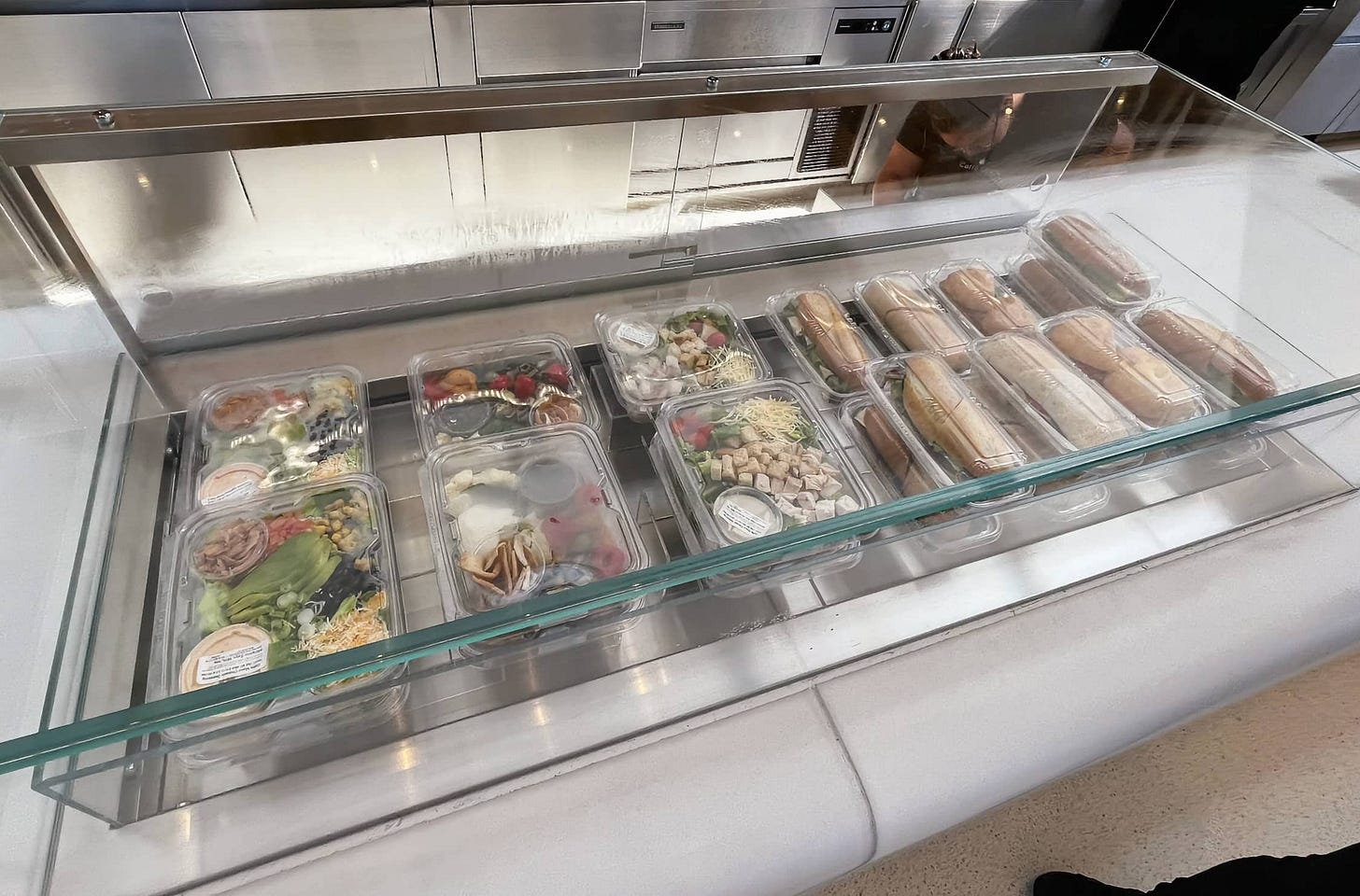 Packaged salads and sandwiches sit in a refrigerated cooler at Apple Park Visitor Center. Packaged salads and sandwiches sit in a refrigerated cooler at Apple Park Visitor Center.