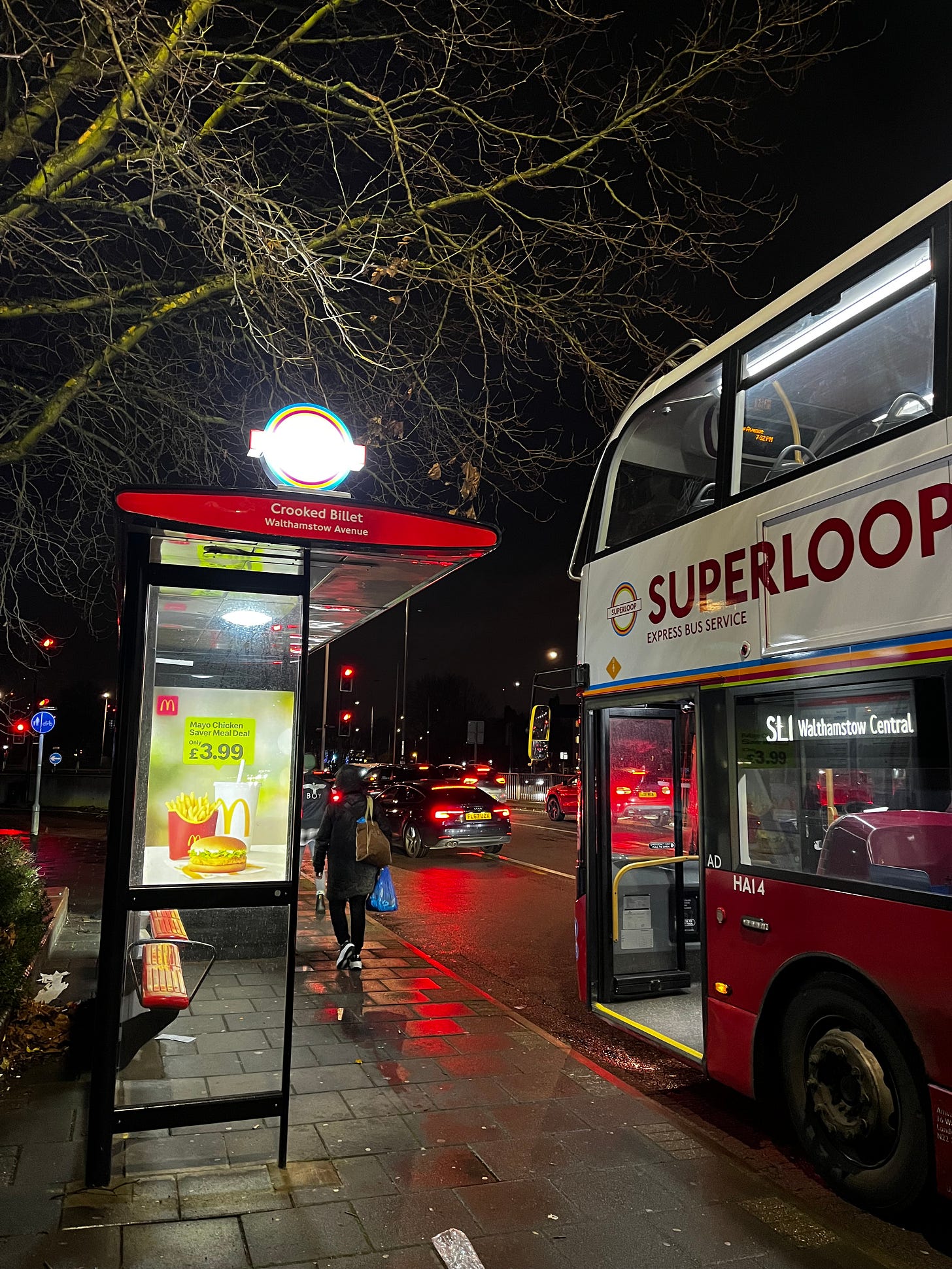 Photo of an SL1 at a bus stop.