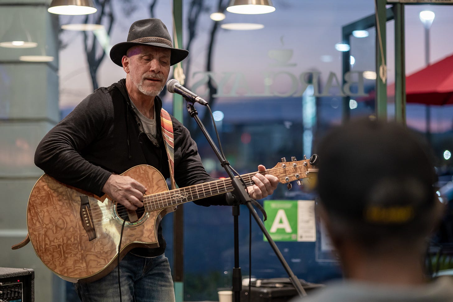 Matthew Moran, songwriter, playing guitar at Barclay's Coffee and Tea