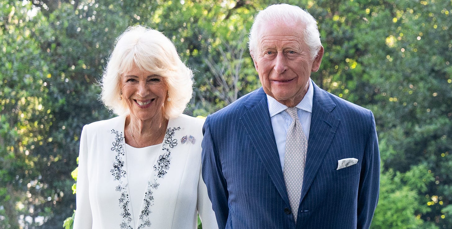 King Charles and Queen Camilla smiling side by side