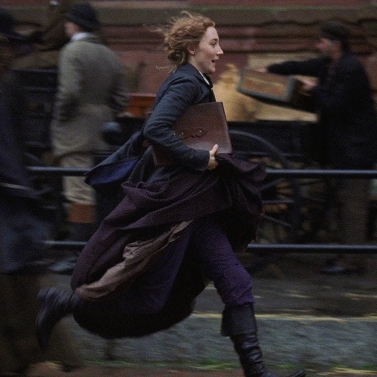 This may contain: a woman is running down the street with a book in her hand as she runs