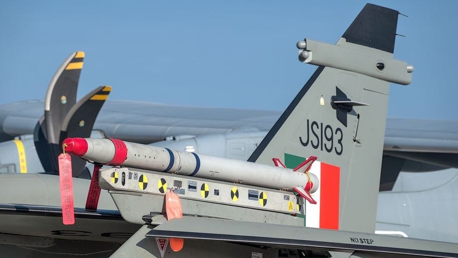 Close-up of an aircraft tail and a displayed missile at Aero India in Bengaluru.