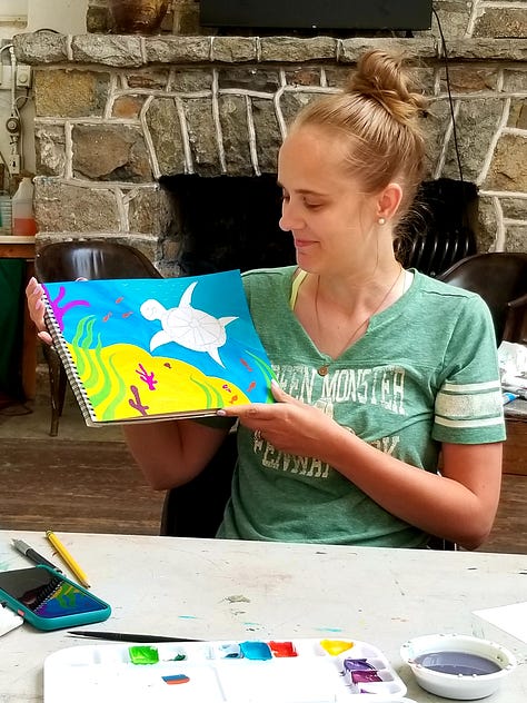 Happy painters holding up their Mary Blair-inspired paintings.