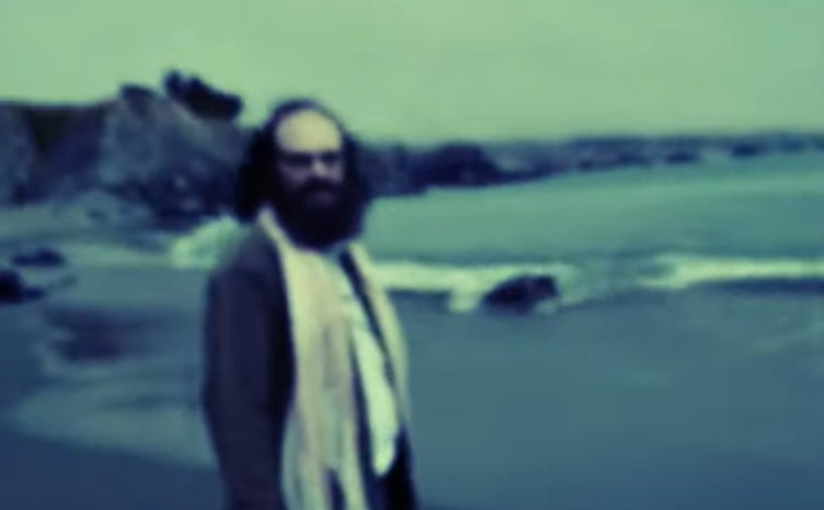 A person with a beard standing on a beach

AI-generated content may be incorrect.