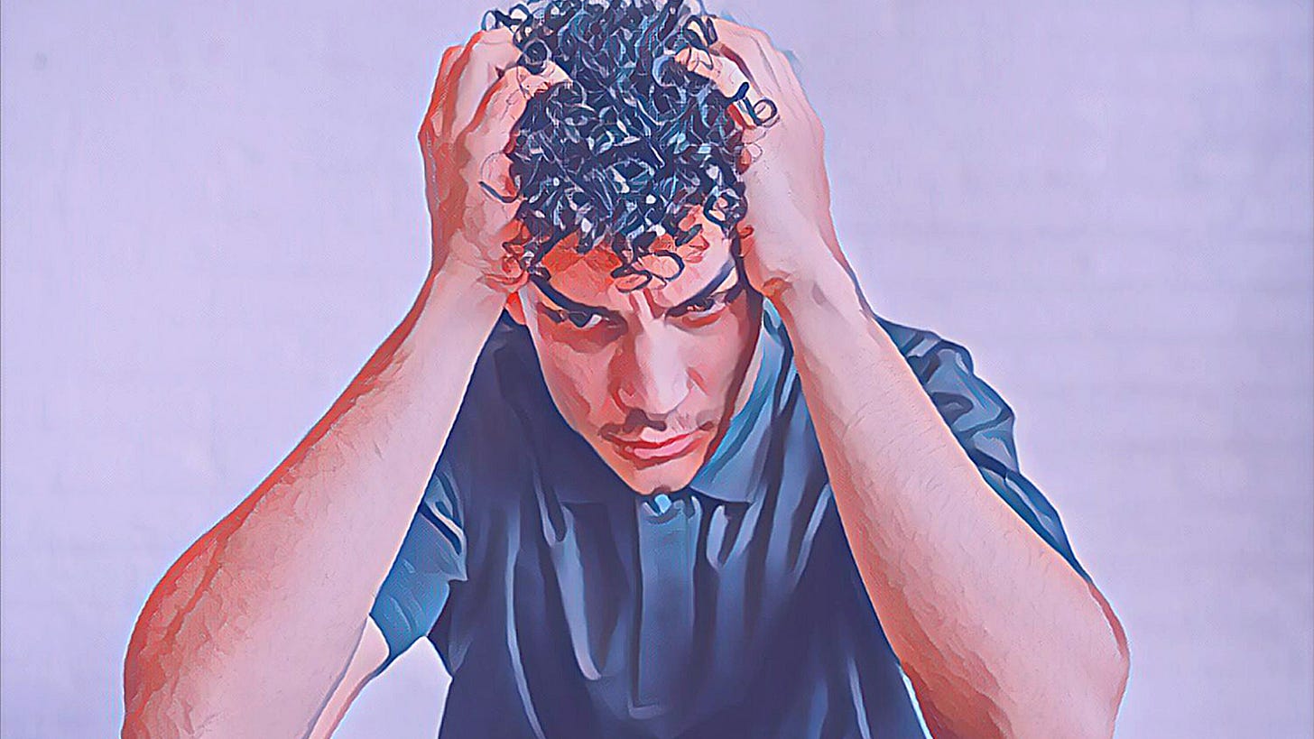 A frustrated young man holding his head. A frustrated young man holding his head.