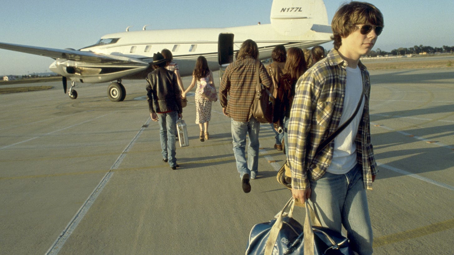 Almost Famous | Still features Patrick Fugit as William Miller walking away from a band plane.