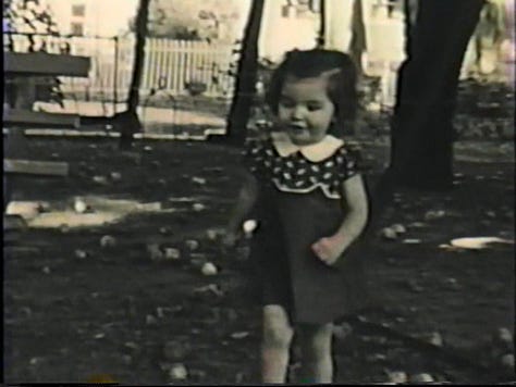 A two-year-old girl walking, parents holding a 1-year-old, and mom pushing a baby carriage in the late 1930s