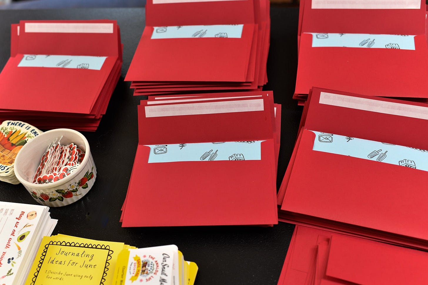 several red envelopes for a snail mail subscription sitting on a table