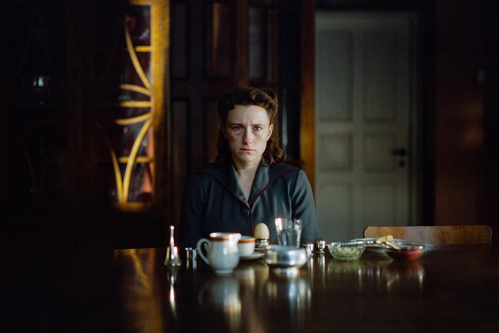 Actress Mathilde Arcel sitting at a table in a dimly lit room in the film Woman Unknown Actress Mathilde Arcel sitting at a table in a dimly lit room in the film Woman Unknown