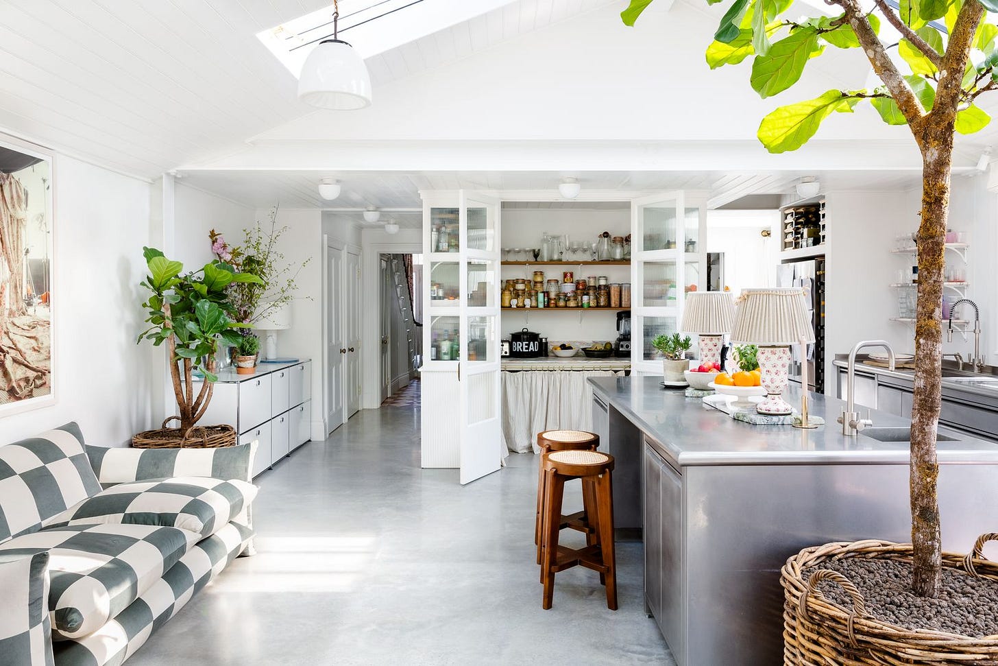 Modern steel kitchen island in open plan residential space with sleek contemporary design Modern steel kitchen island in open plan residential space with sleek contemporary design