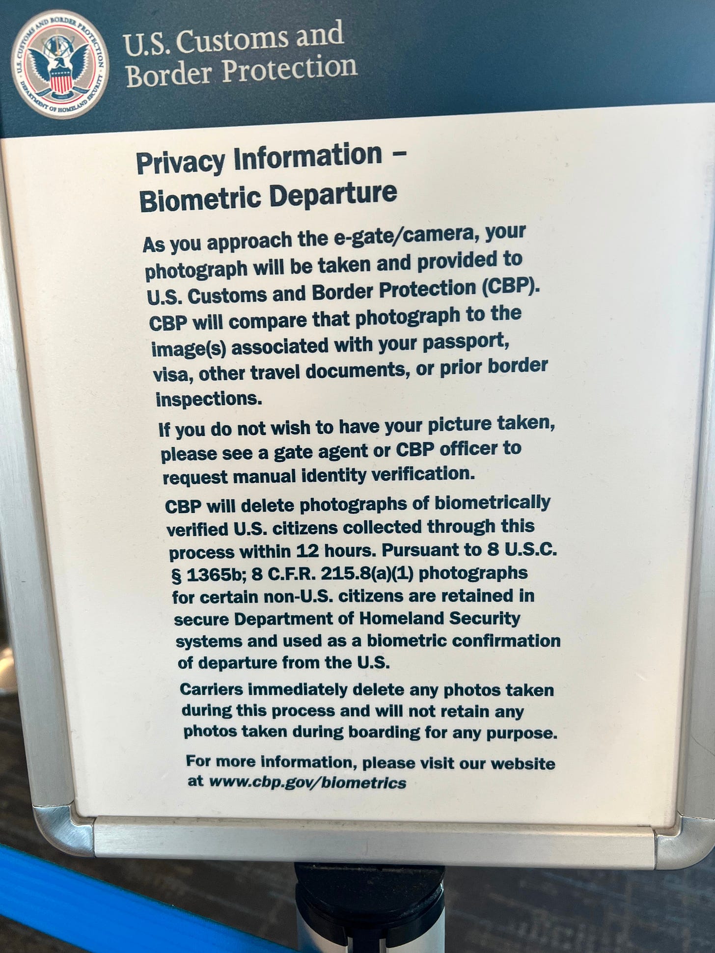 US Customs and Border Protection sign stating your photograph is taken before you board a plane. 