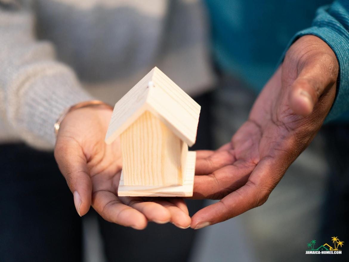 person holding miniature wooden house