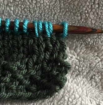 Knitting stitches on needle