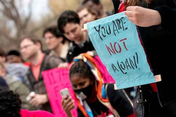 A group of people holding signs

Description automatically generated with medium confidence