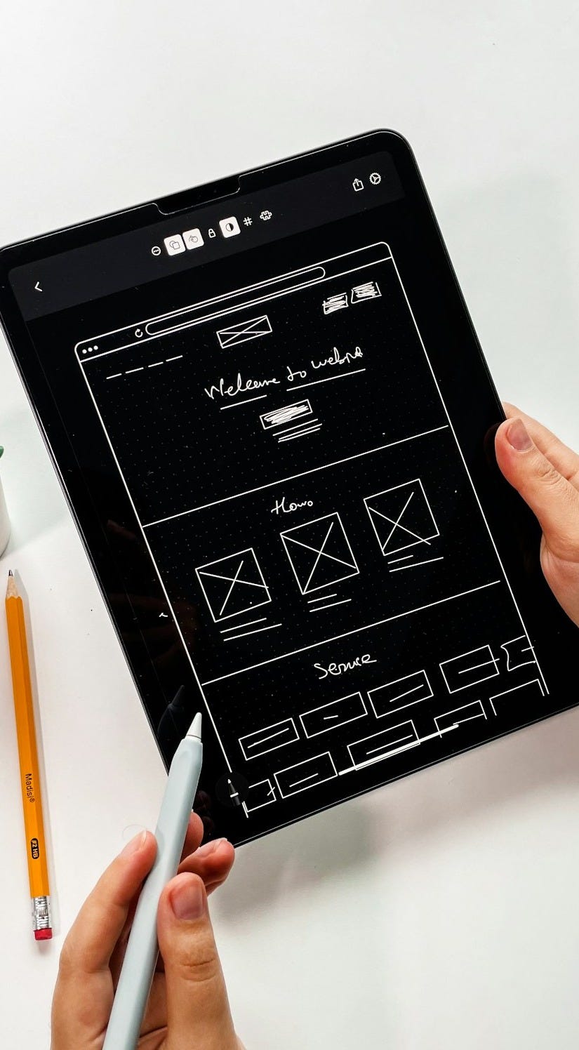 person holding black ipad with green plant person holding black ipad with green plant