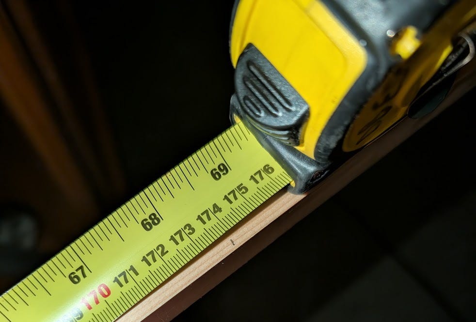 yellow tape measure with yellow tape extending from it
