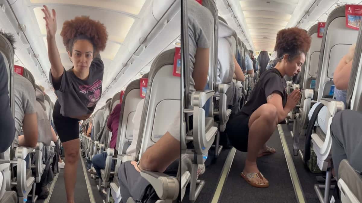 Woman stretching on plane in middle of aisle Woman stretching on plane in middle of aisle