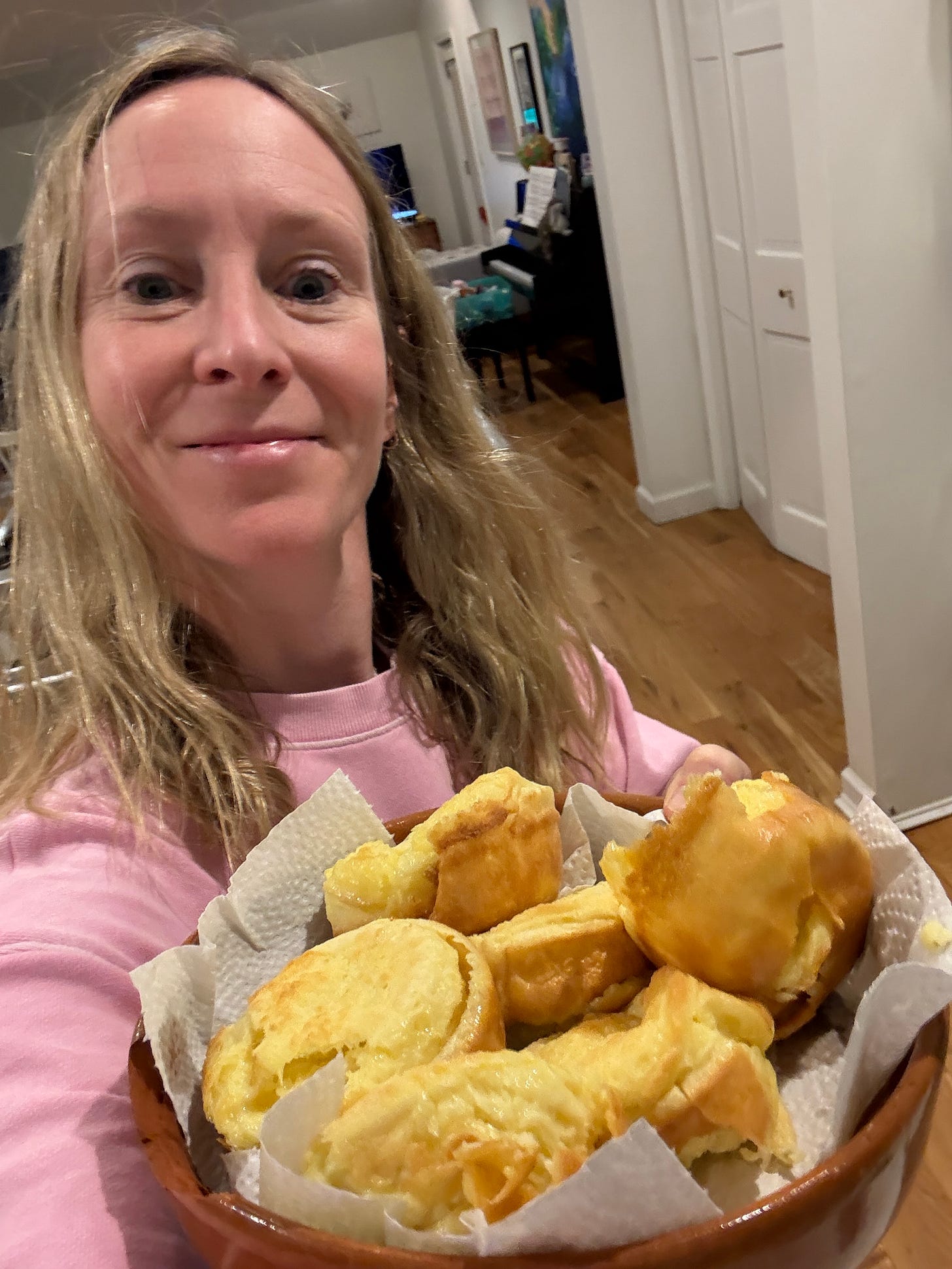Woman holding a bowl of freshly-baked yorkshire pudding