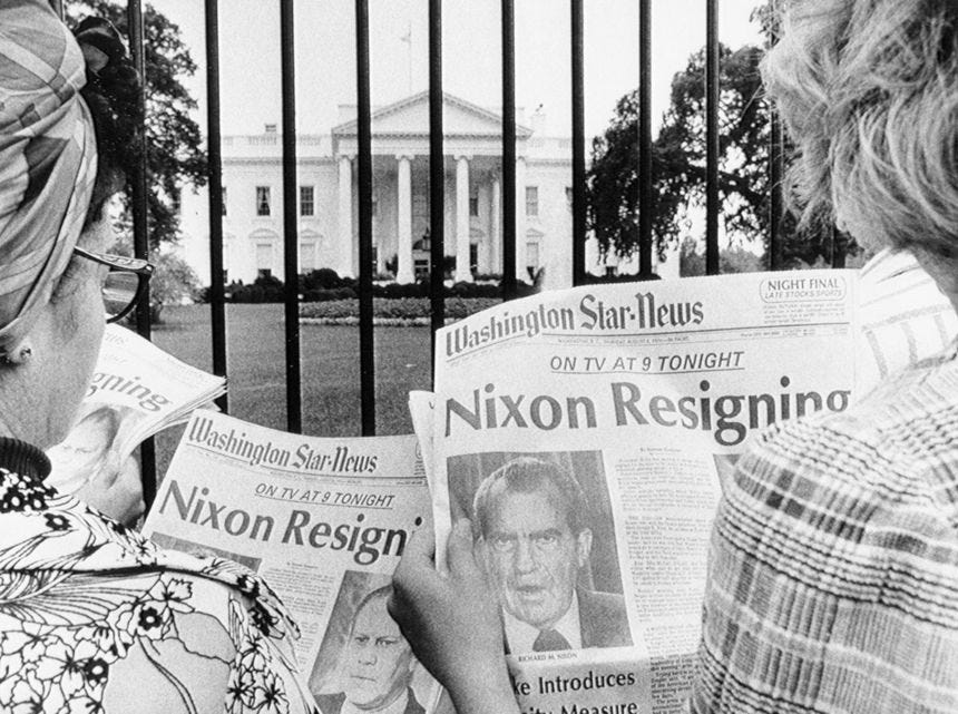 Tourists outside the White House read news of Nixon's impending resignation on August 8, 1974. Tourists outside the White House read news of Nixon's impending resignation on August 8, 1974.