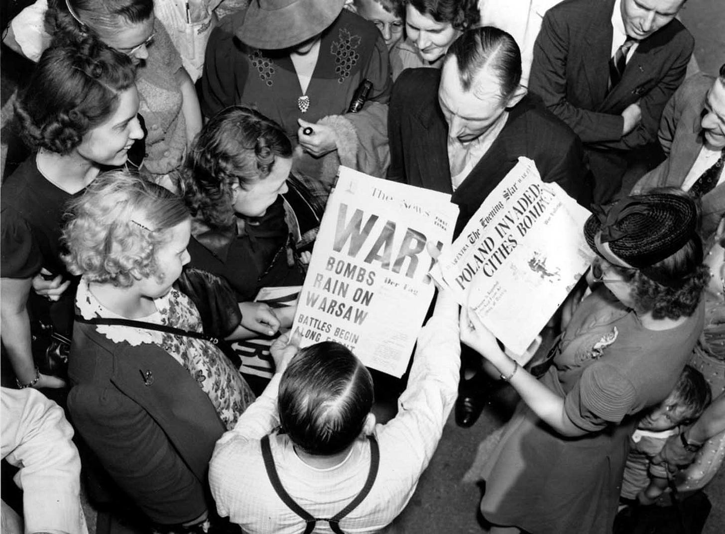 A crowd in Washington D.C. reads 'Bombs Rain On Warsaw' headlines outside the U.S. State Department on September 1, 1939, as diplomats discuss the escalating European conflict. A crowd in Washington D.C. reads 'Bombs Rain On Warsaw' headlines outside the U.S. State Department on September 1, 1939, as diplomats discuss the escalating European conflict.