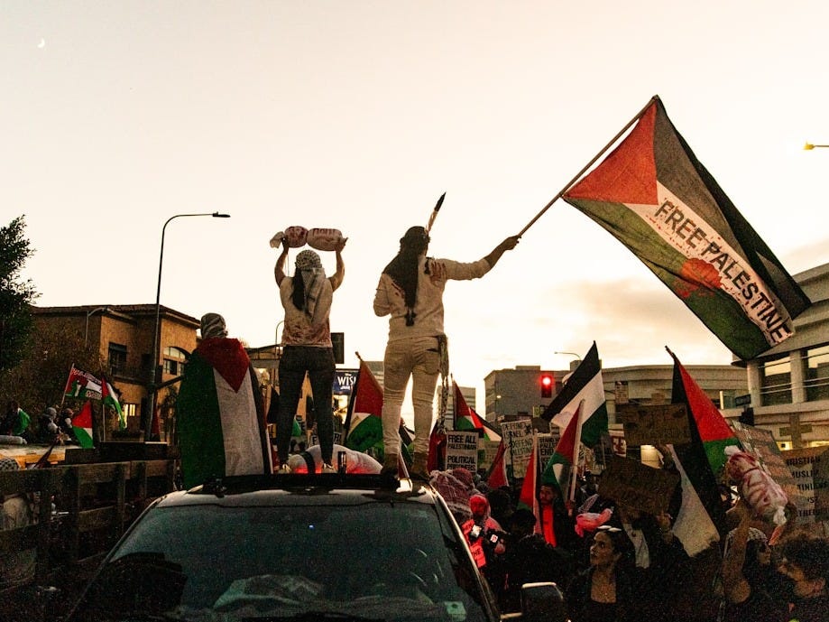 a group of people standing on top of a truck a group of people standing on top of a truck
