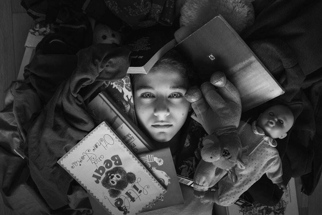 a boy holding a teddy bear and a book a boy holding a teddy bear and a book
