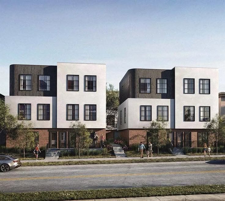 This may contain: two story townhouses on the corner of a street