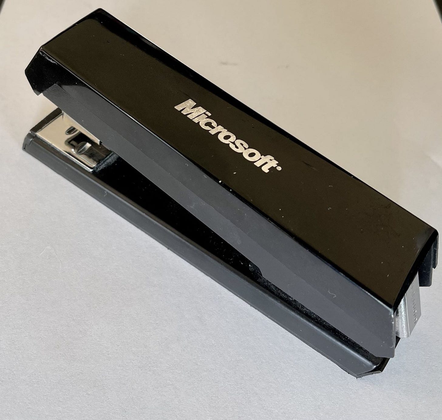 A standard stapler with a Microsoft imprint logo.