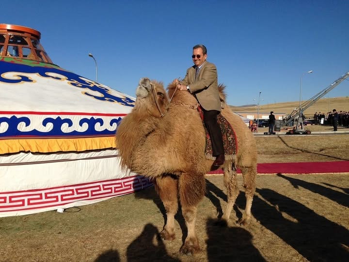 May be an image of 4 people and Bactrian camel