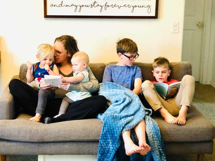 3 children sitting on gray couch