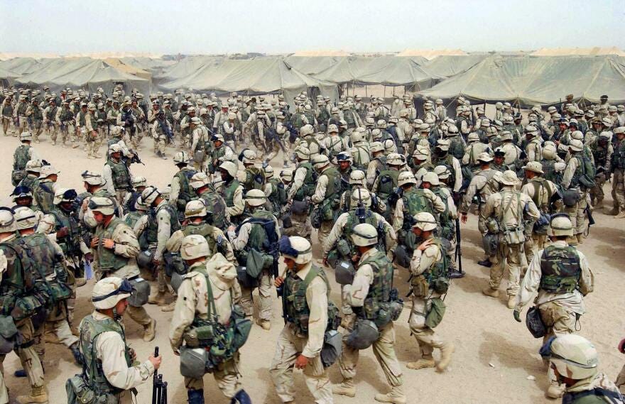 March 20, 2003: U.S. Marines prepare themselves after receiving orders to cross the Iraqi border at Camp Shoup, in northern Kuwait. March 20, 2003: U.S. Marines prepare themselves after receiving orders to cross the Iraqi border at Camp Shoup, in northern Kuwait.