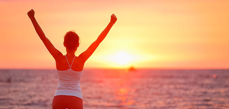 Person happy on the beach sunset