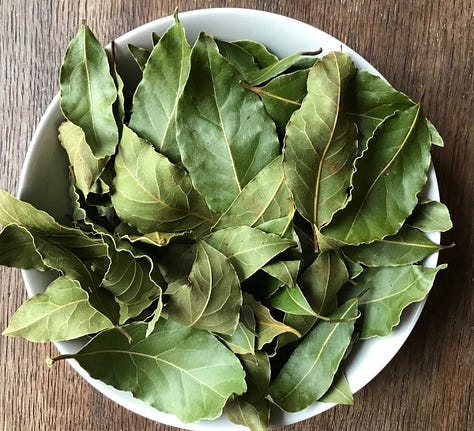 Dried green bay leaves, orange marigold petals, pink rose petals, green nettle leaves