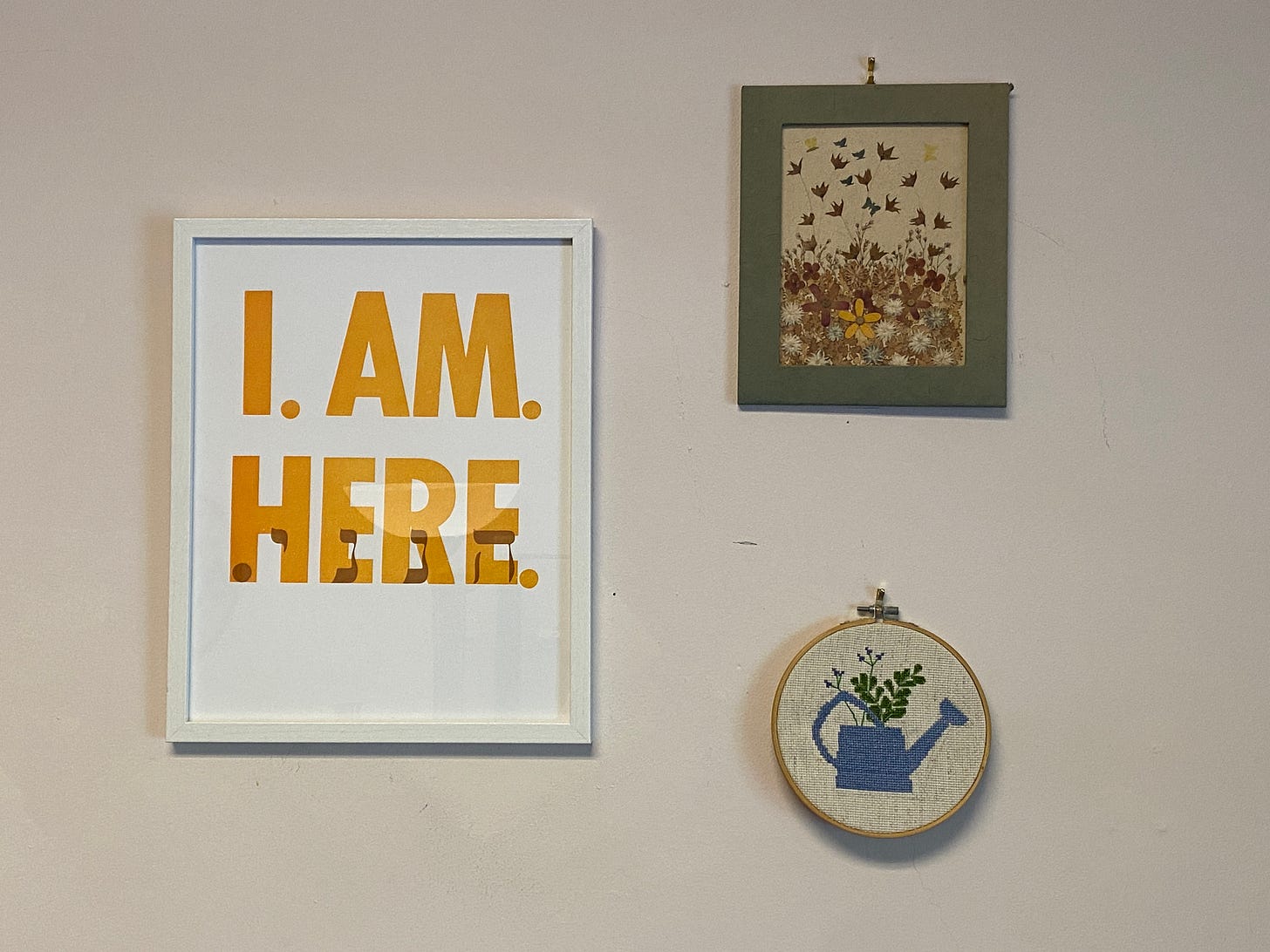 art with flowers and a print that says 'i am here'