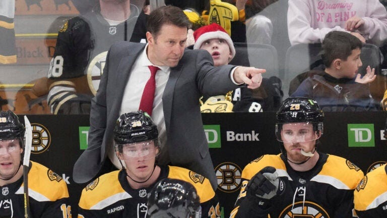 Boston Bruins interim head coach Joe Sacco points while talking with an official during the first period of an NHL hockey game against the Washington Capitals, Monday, Dec. 23, 2024, in Boston.