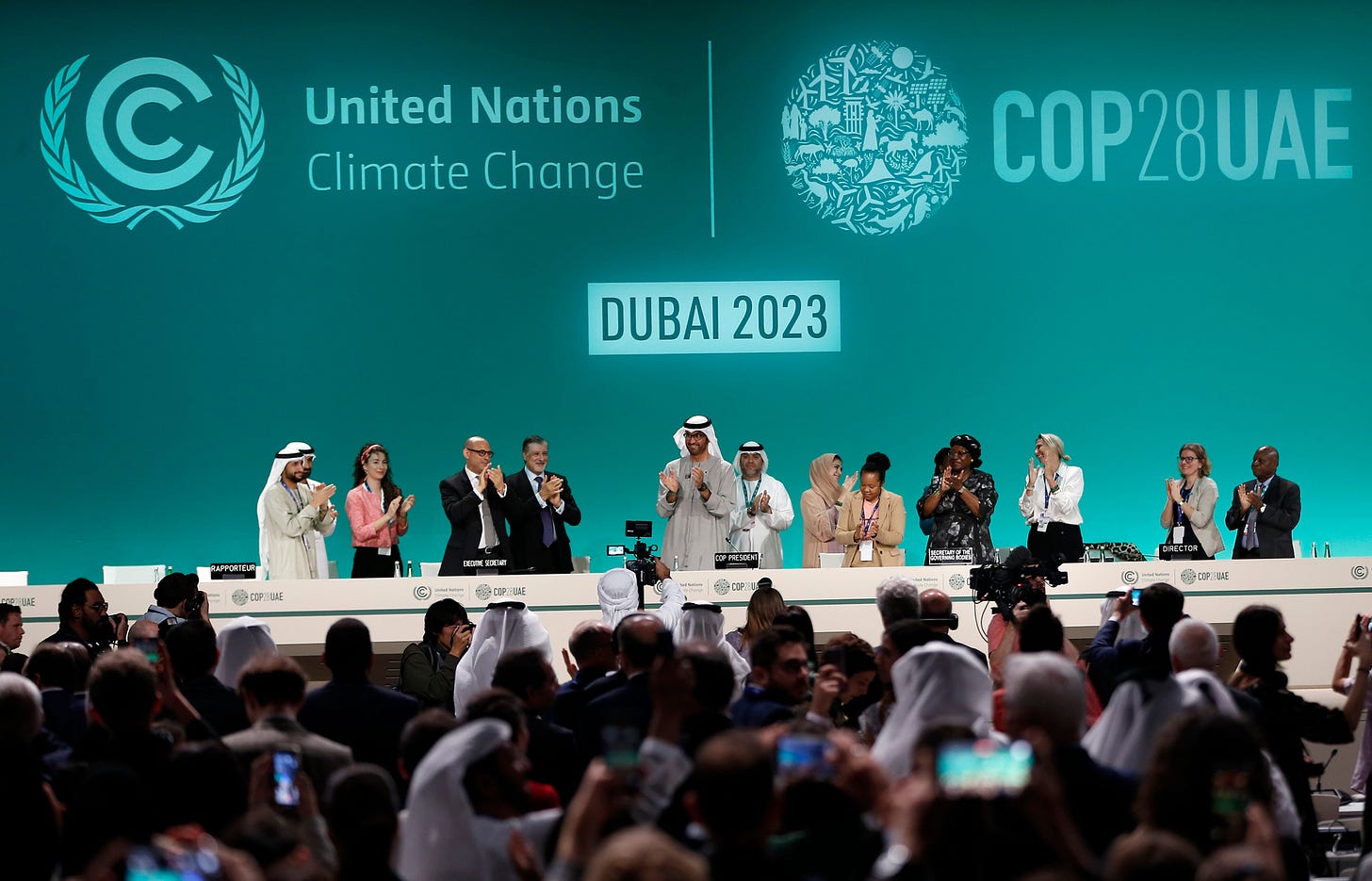 Attendees applaud after announcement of UAE consensus during a closing plenary of COP28 on Dec. 13. Credit: Wang Dongzhen/Xinhua via Getty Images