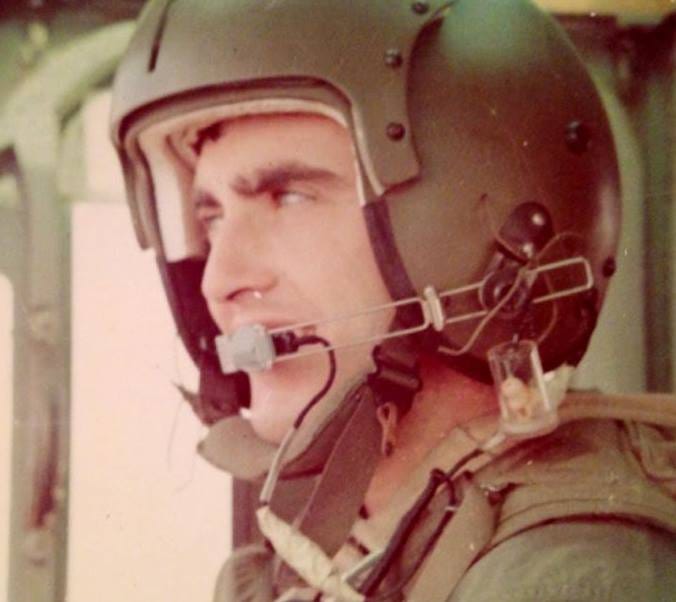 White man wearing a helmet. Vietnam era helicopter pilot.