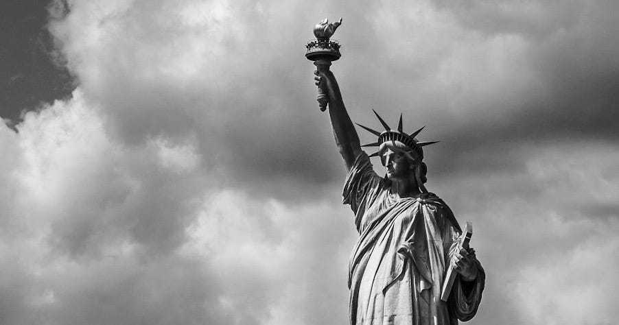 Statue of Liberty under cloudy sky during daytime Statue of Liberty under cloudy sky during daytime