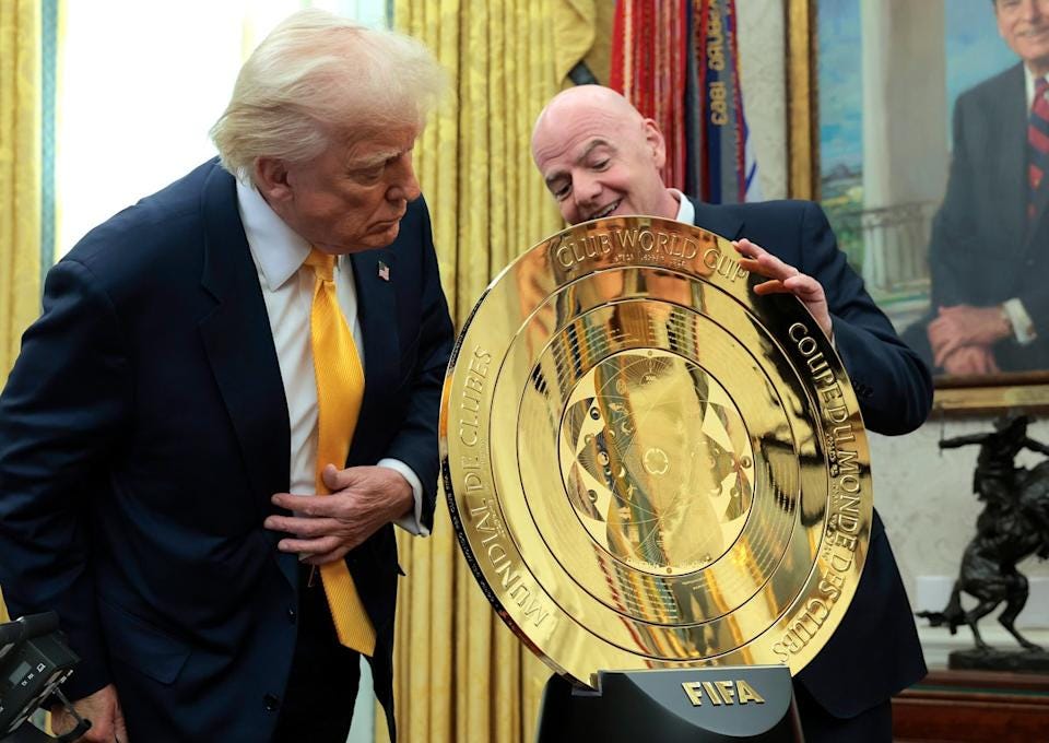 Trump and FIFA chief executive unveil the new golden Club World Cup shield in the Oval Office (Getty)