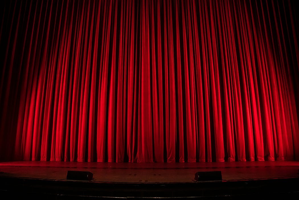theater stage. red curtains closed, prepared for the start of the show. theater stage. red curtains closed, prepared for the start of the show.
